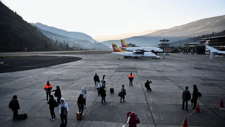 Passengers crossing the apron at Paro airport
