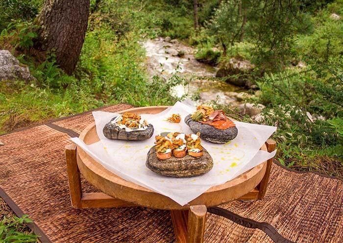 Outdoor picnic table laid with Bhutanese delicacies