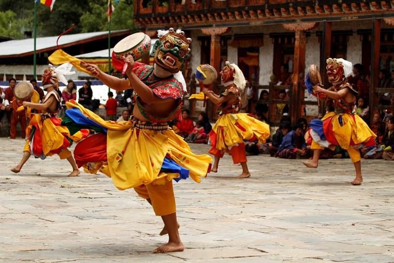 Masked cham dancers performing at a Bhutanese festival