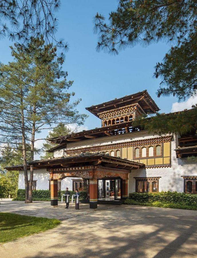 Hotel entrance framed by pines in Paro