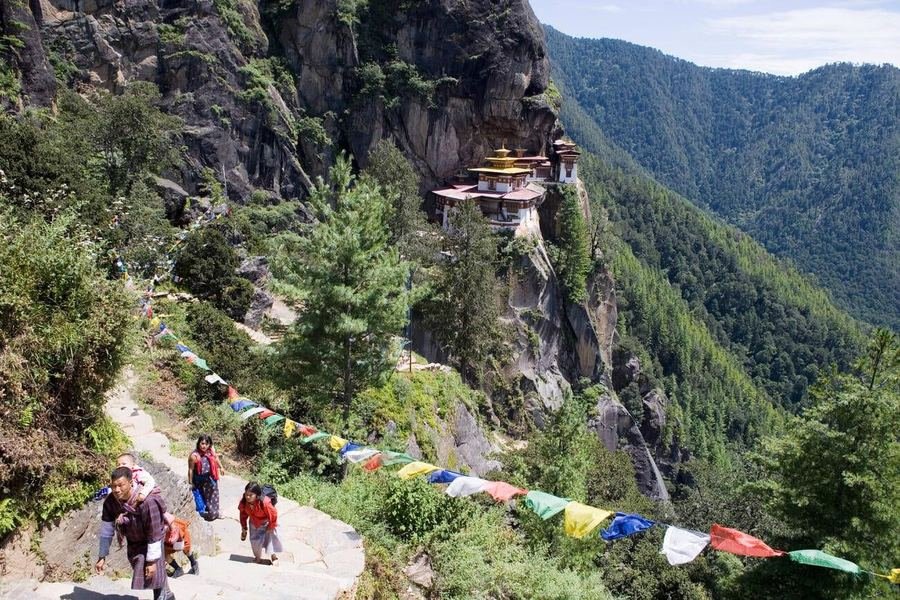 Trekkers on the prayer-flag-lined trail to Tiger&rsquo;s Nest