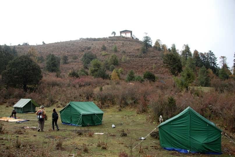 Camp tents pitched on the meadow below Jele Dzong