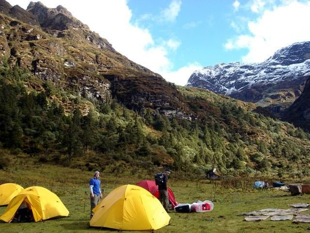 Yellow tents pitched beside the alpine lake