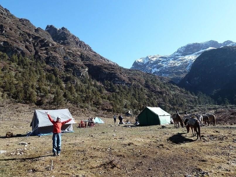 Camp crew and pack horses at the lakeside camp