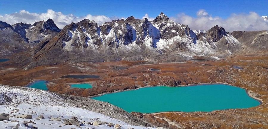 Turquoise glacial lakes below snow-covered peaks