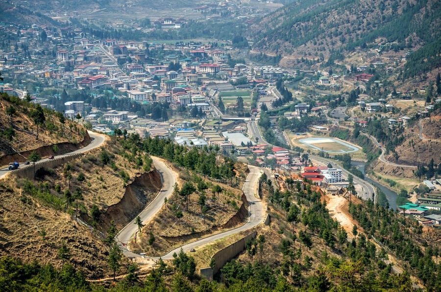 Winding road descending into Thimphu