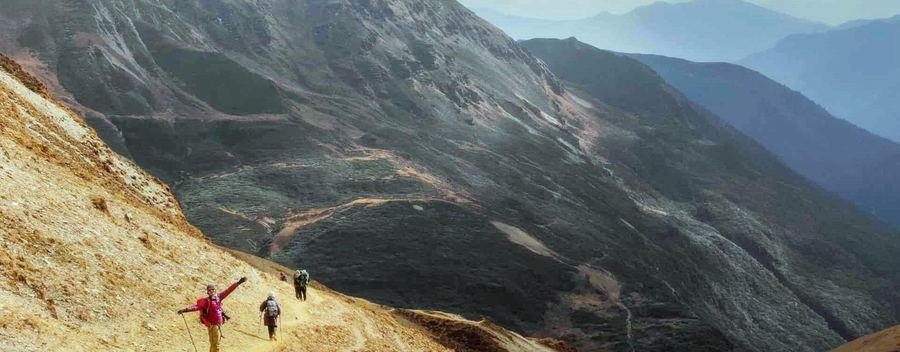 Trekker on a ridge trail high above the valley
