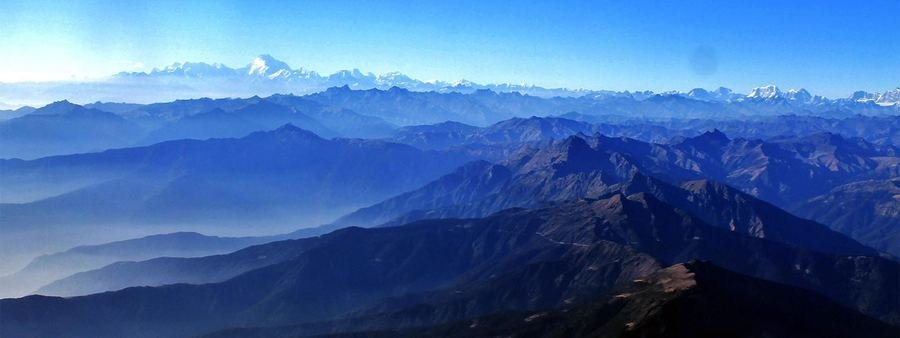 Layered blue Himalayan ridgelines at dawn