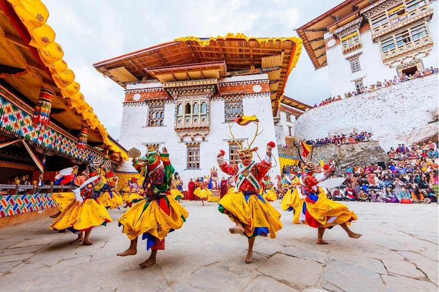 Masked cham dancers performing at a Bhutanese tshechu