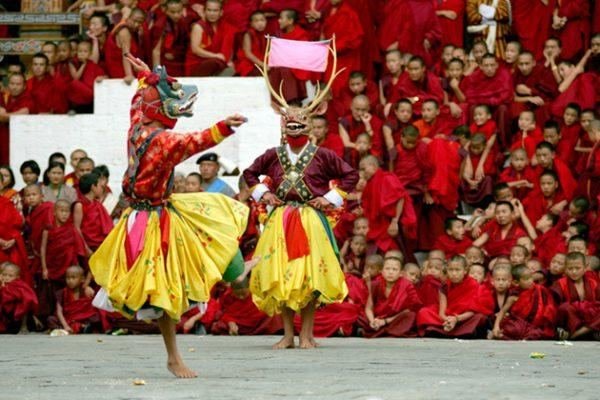 Dancer performing before rows of young monks