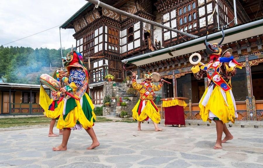 Masked dancers performing in a temple courtyard