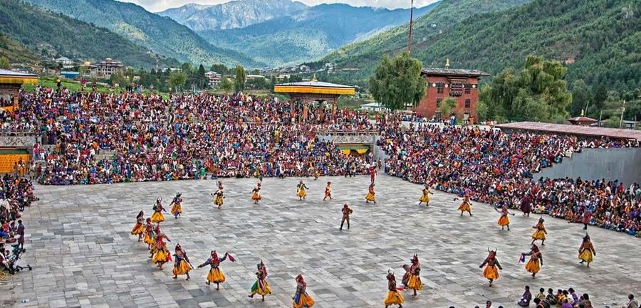 Festival crowd filling the dzong courtyard, seen from above