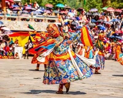 Masked dancer in brocade robes mid-spin