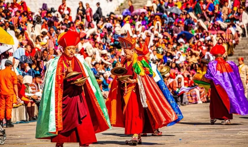 Dancers in ceremonial silk before a packed audience
