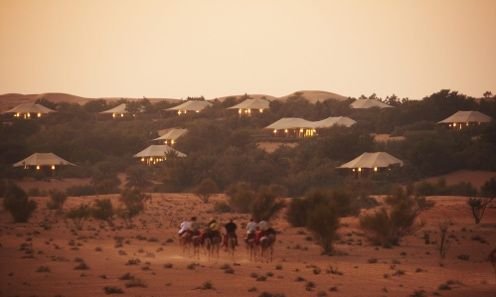 Luxury desert resort villas at dusk in the Dubai Desert Conservation Reserve