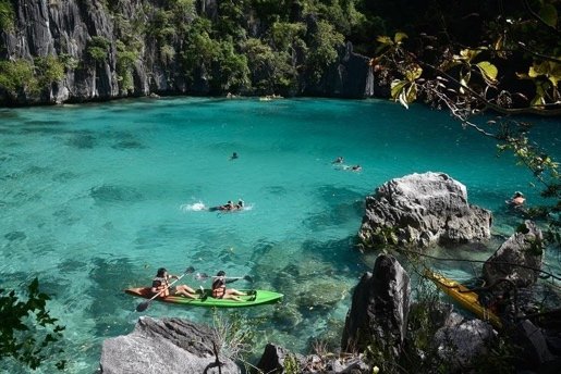 Kayakers on the clear green water of Twin Lagoon