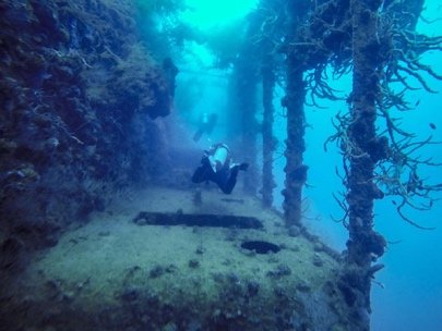 Diver moving through the columned interior of a wreck