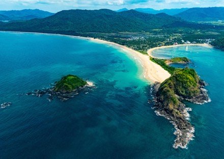 Aerial view of the long curving sand of Nacpan Beach