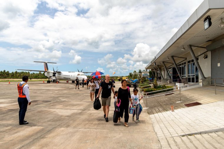 Guests walking from a turboprop aircraft to the Sayak Airport terminal, Siargao