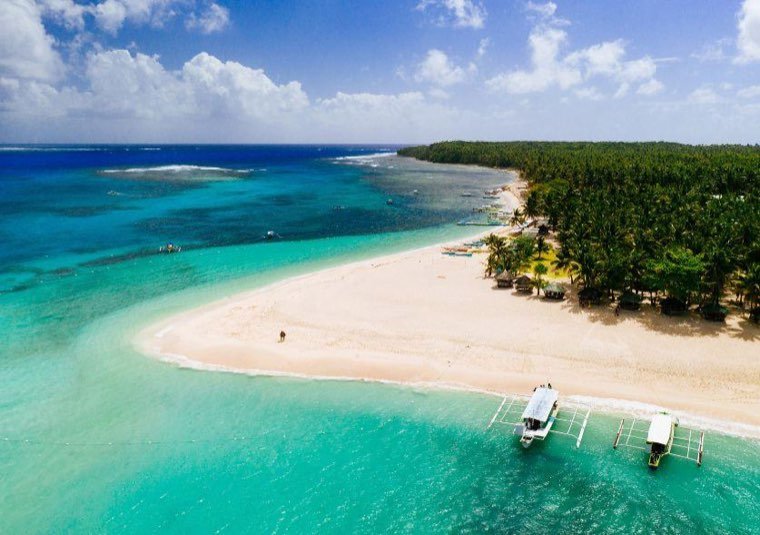 Bangka boats moored off the white sandbar of Naked Island