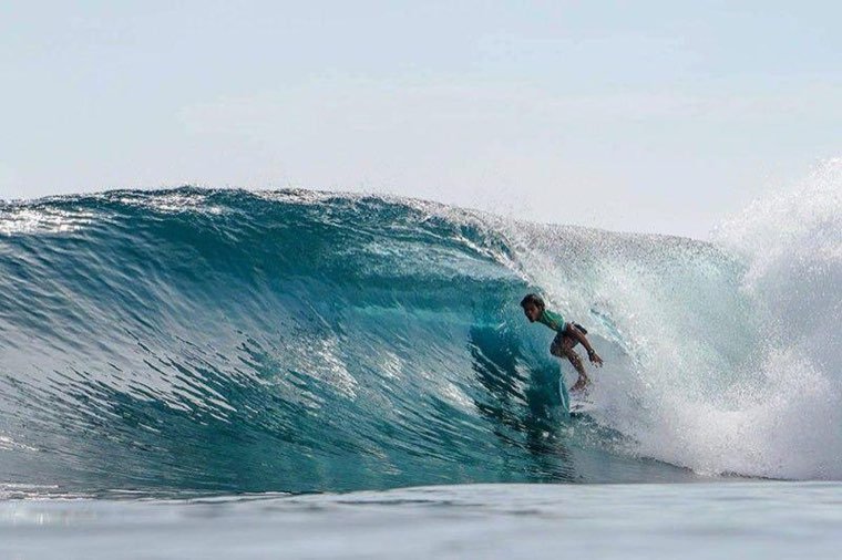 Surfer riding inside the barrel of a wave at Cloud 9, Siargao