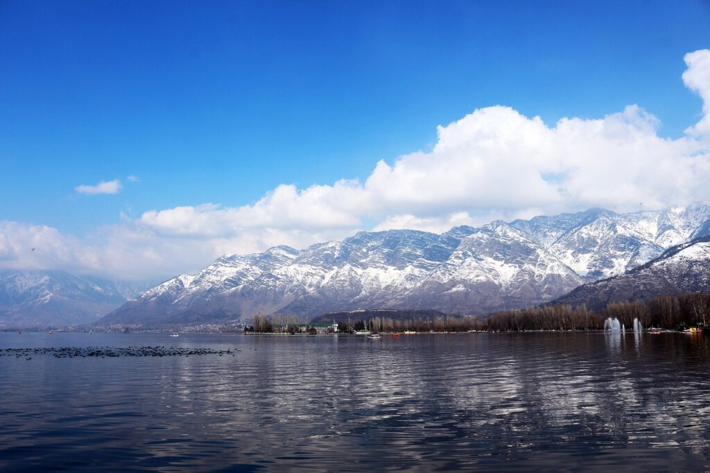 **"Dal Lake – The jewel of Srinagar, featuring serene waters, floating houseboats, vibrant shikaras, and breathtaking views of the surrounding Himalayas."**