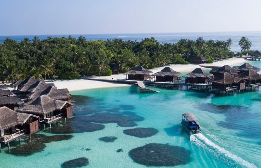 Luxury overwater bungalows at Anantara Veli Maldives Resort in South Malé Atoll, Maldives – adults-only island retreat with crystal-clear lagoon and tropical surroundings.