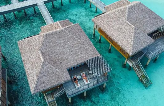 Overwater villa at Barcelo Whale Lagoon Maldives in South Ari Atoll, featuring thatched roof, private sun deck, direct lagoon access, and panoramic views of the Indian Ocean.